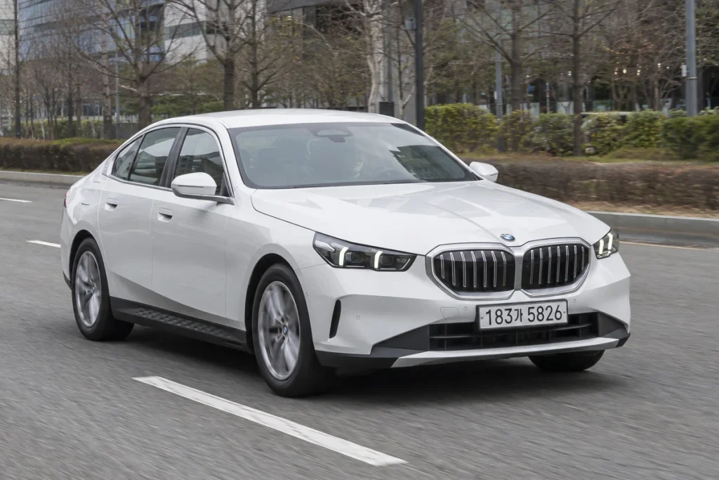 흰색 BMW 세단의 주행 모습